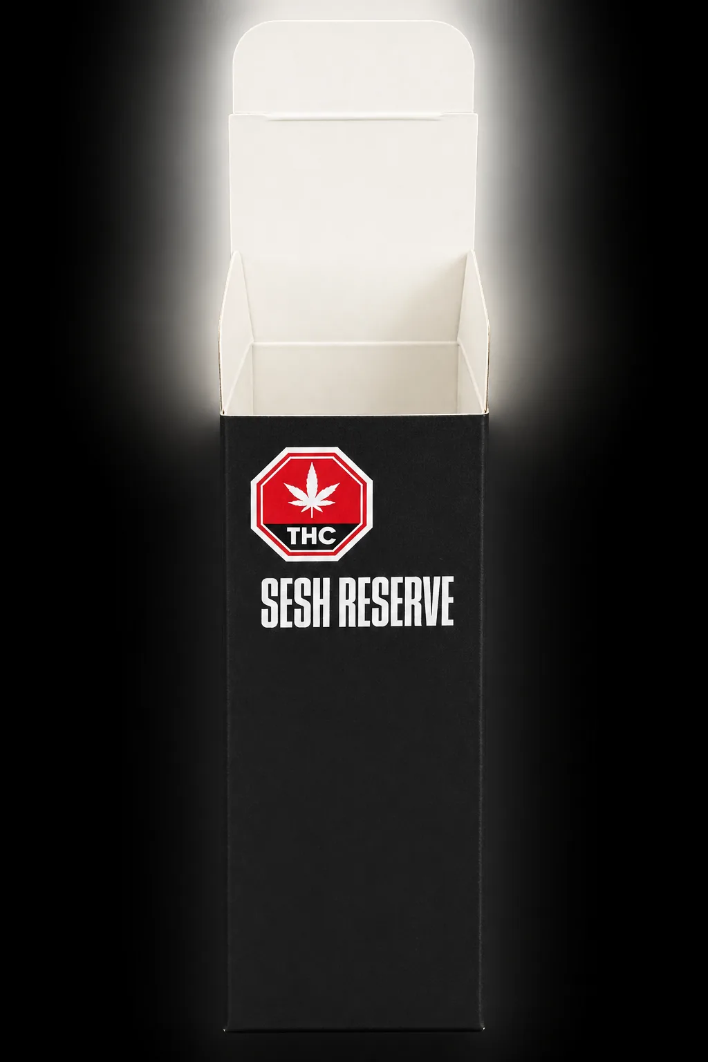 Black custom printed folding carton with open reverse tuck lid, produced by Lion Packaging